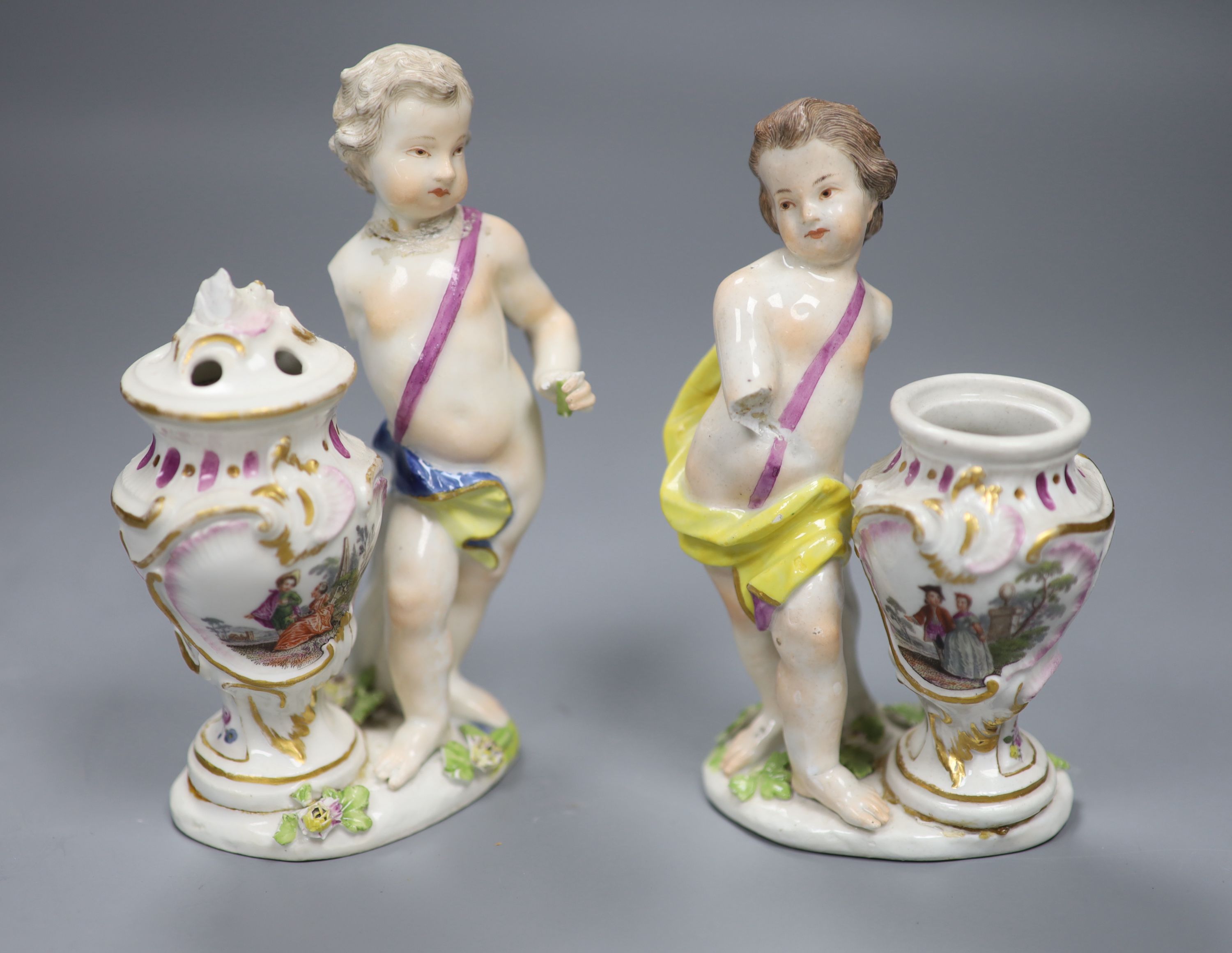 A pair of 18th century Meissen figures of putti and vases, height 14cm